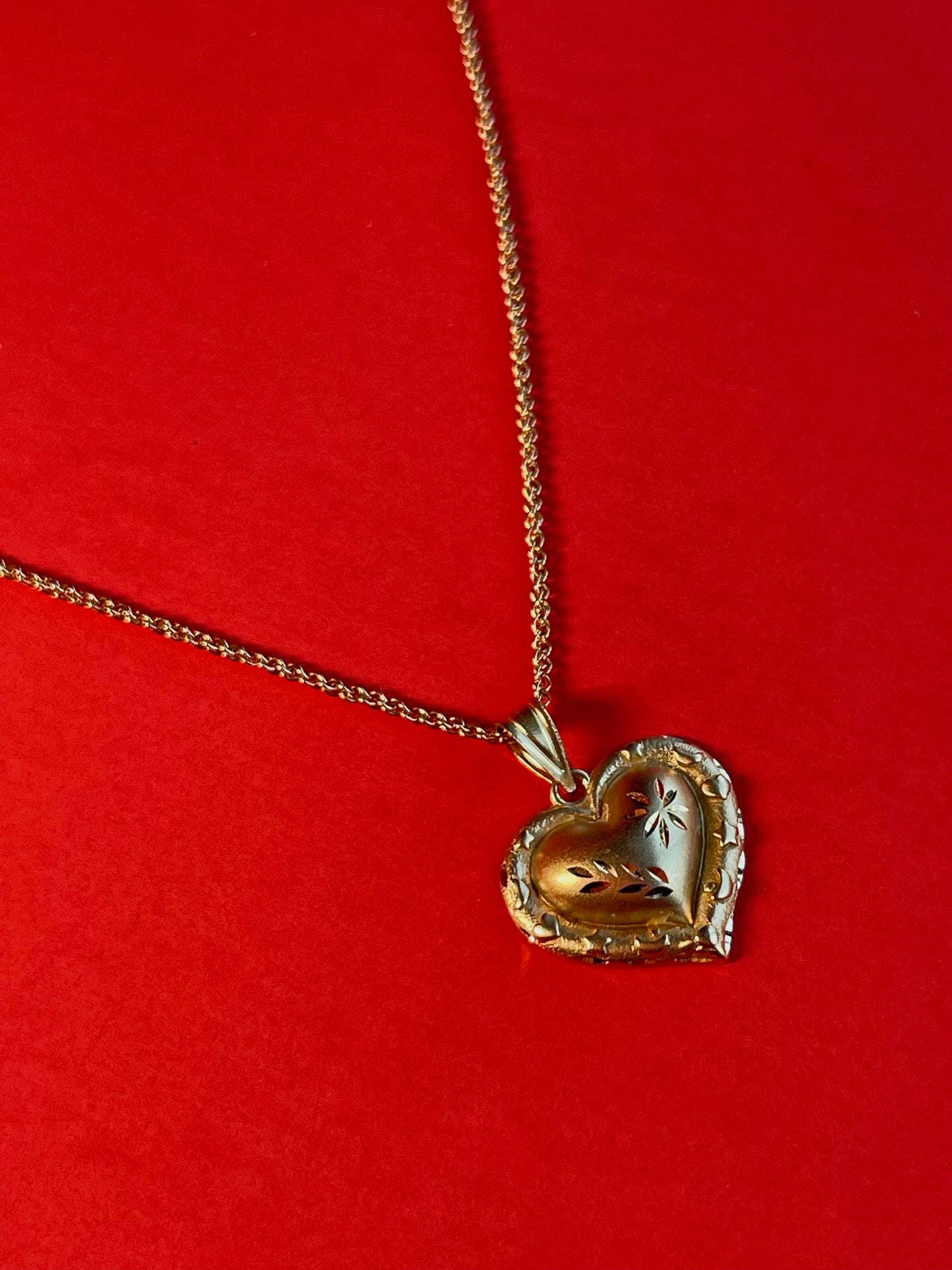 Vintage 14k Gold Heart Pendant Enchanted with Delicate Floral Carvings and a Border of Celestial Symbols