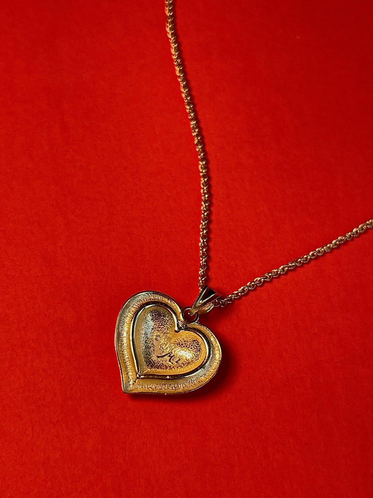 Vintage 14k Gold Heart Pendant Enchanted with Delicate Floral Carvings and a Border of Celestial Symbols