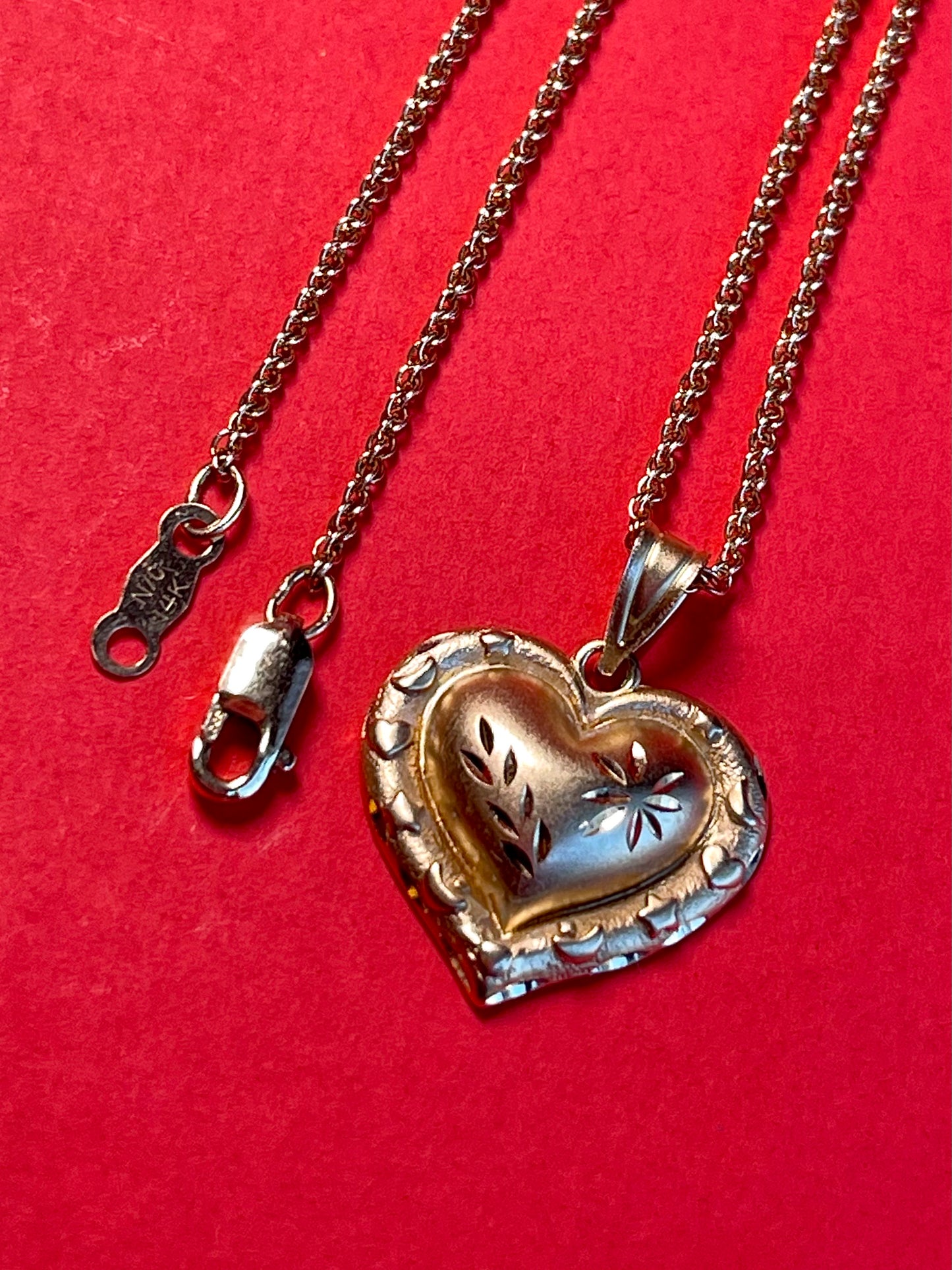 Vintage 14k Gold Heart Pendant Enchanted with Delicate Floral Carvings and a Border of Celestial Symbols