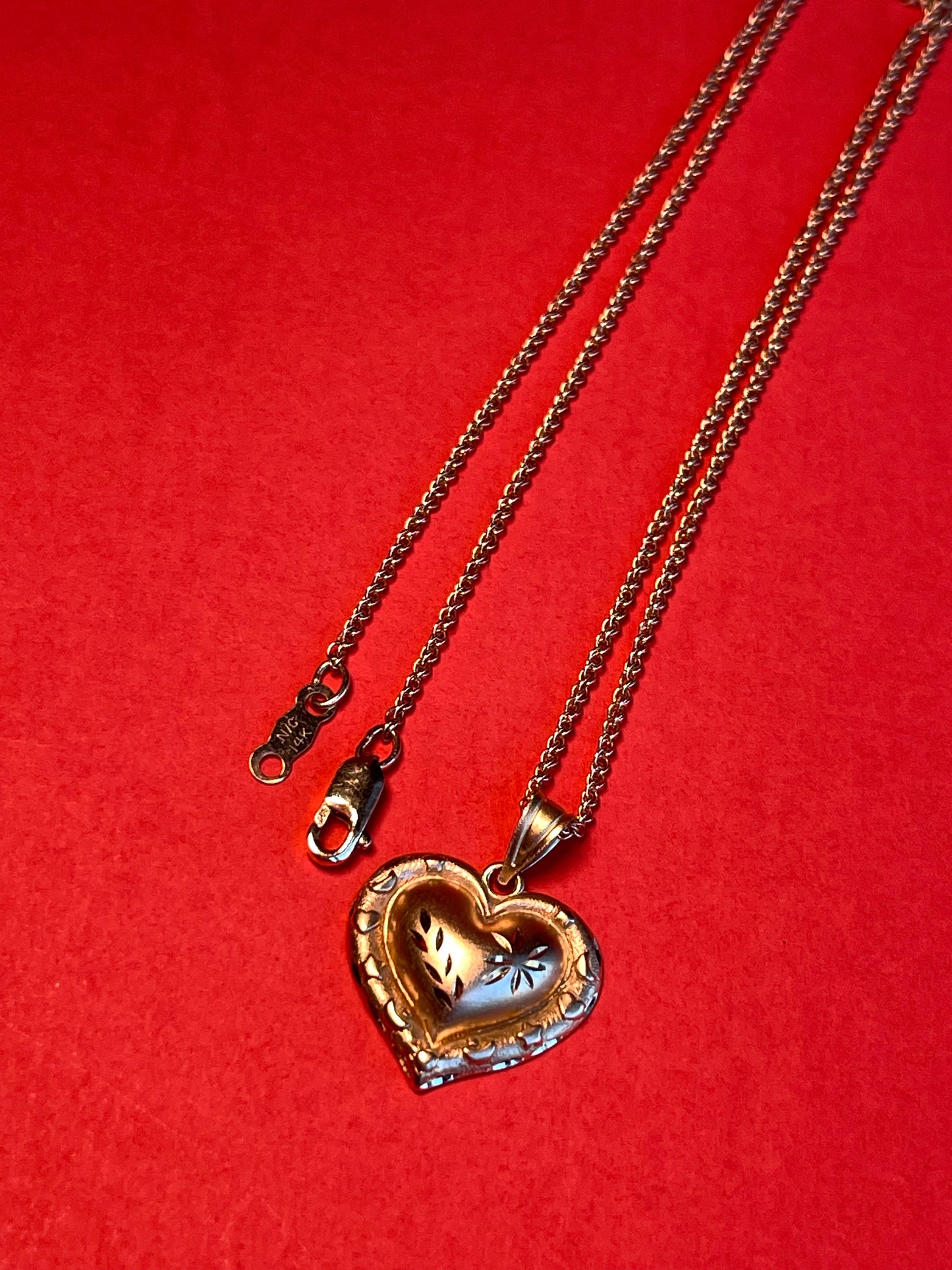 Vintage 14k Gold Heart Pendant Enchanted with Delicate Floral Carvings and a Border of Celestial Symbols